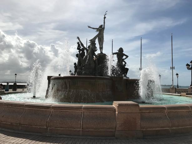 This is known as “Las Raices” Fountain. It symbolizes the roots of Puerto Rican culture. This popular memorial is located on Paseo de la Princesa where street vendors and markets fill up the pathway. 
