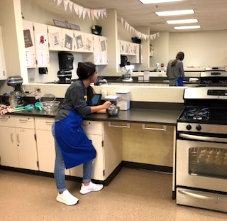 Freshman Tori Silvar bakes dinner rolls in Family and Consumer Science Class. The class teaches freshmen students about child development, family relations, cooking and baking skills. 