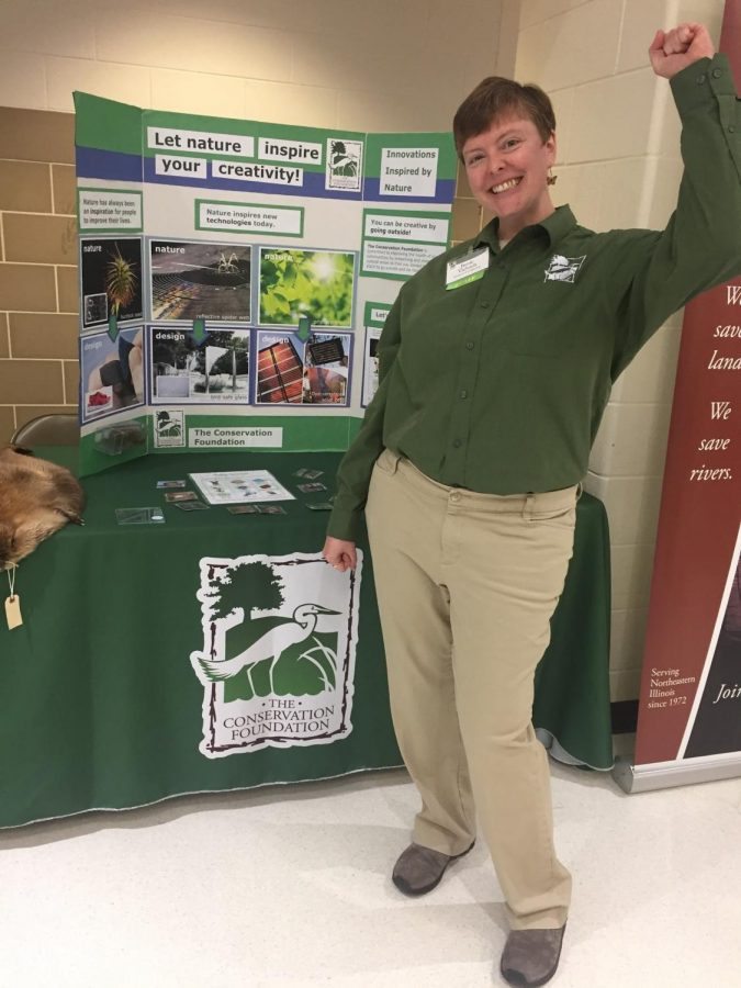 Jamie Viebach, a volunteer from the Conservation Foundation shows her enthusiasm for STEAM night. Her station included a beaver skin and a mirror for her demonstrations.