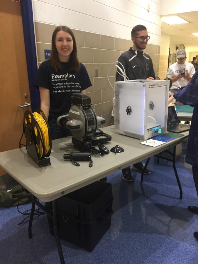 Volunteers Lindsay Selfridge and Damian Kowalczyk pose with their instruments (a deep-sea ROV and 3D printer). ROVs can dive thousands of feet underwater and explore ancient shipwrecks, thermal vents, and ocean animal habitats.