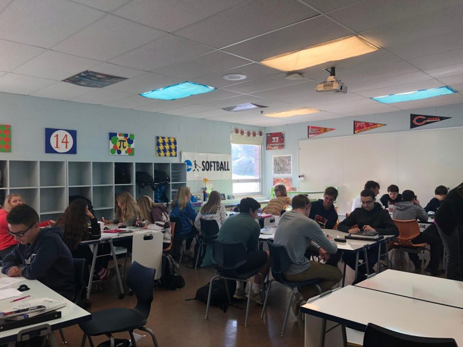 Students+in+Mrs.+Johnson%E2%80%99s+math+class+are+utilizing+the+whiteboard+desks+to+practice+problems.+The+whiteboard+desks+are+currently+aiding+them+to+learn+how+to+graph+quadratic+functions+using+a+table+of+values+and+an+axis+of+symmetry.++