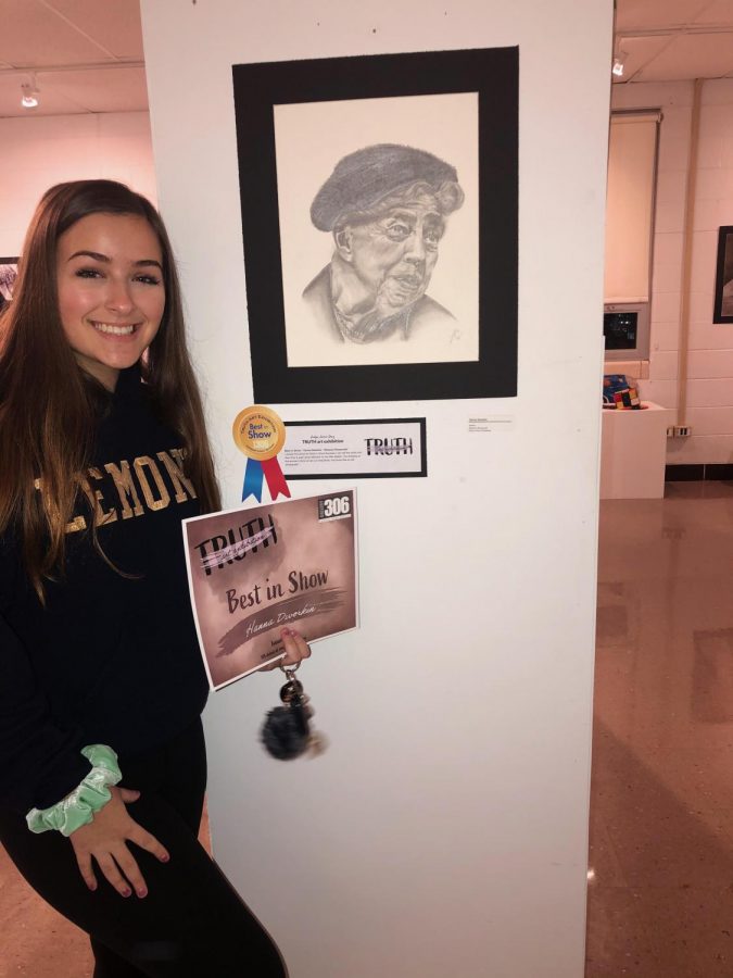 Senior Hanna Dworkin accepts her award for “Best in Show  for her graphite drawing of Eleanor Roosevelt. Dworkin is inspired by influential American icons that have made a great impact on society. 