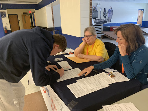 Junior Christopher Calhoun, who will turn 18 on Oct. 14, 2020, registering to vote during his A lunch period. Volunteers from the Cook County Register, Laura Derks and Sharon Storveck, made sure Calhoun filled out the application, which took him five minutes to fill out, correctly. Calhoun said, “I feel its your duty as your citizen to vote. Its a right that people in a lot of other countries don’t have.”