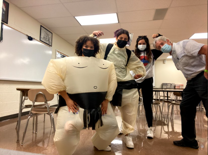 Senior Kaitlyn Devitt and her friends pose with teacher Mr. Jordan in their sumo costume for sports day.
