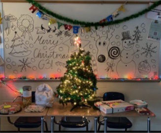 The decorating committee spent time drawing on the whiteboard and bringing in lights and a tree to help make the room more festive. 
