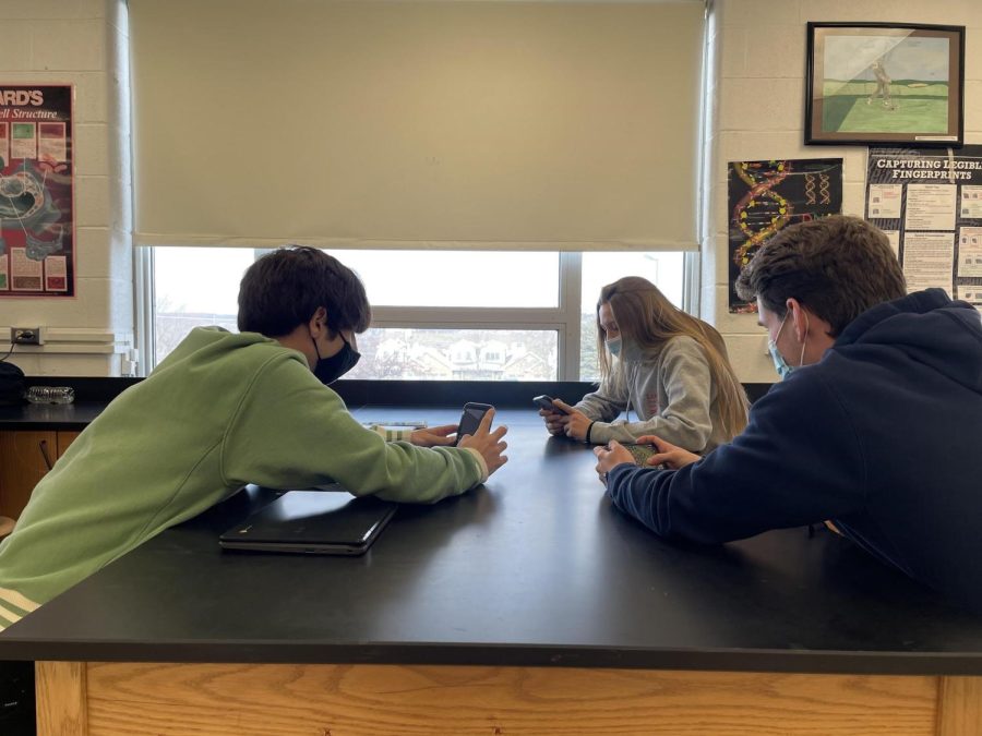 Seniors Van Gaetto, Joanna Machaj and Andrew Tilly sitting at their lab table in AP Biology awaiting class instruction. 
