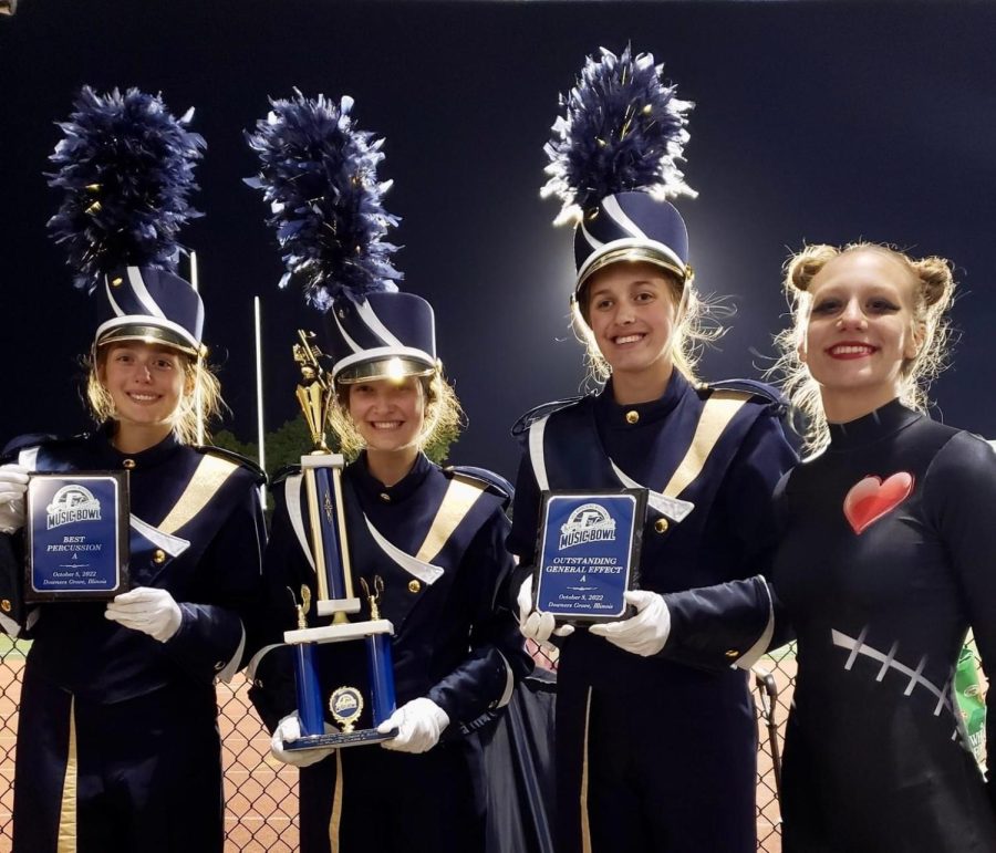 From left to right: drum majors Toni Sarussi, Destina Sarussi and Alyssa Greer. Section leader of the color guard, Elise Mandell also represented the guard at the awards ceremony Oct. 9 at the Downers Grove South Marching Mustangs Music Bowl.