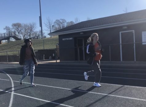 Juniors Ruby Kraker and Avary Blazevich “trot” the final stretch of the course.