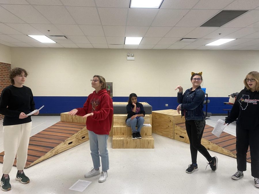 From left to right, Group Interpretation members Barbie Lesa, Karolina Granat, Neha Samuel, Kaitlyn O’Donnel and Taliana O’Connor rehearse a scene at Group Interpretation practice. These five members are only a fraction of the 11-member cast. During the performance, all members will be present on the set interpreting the scene and telling the story. 