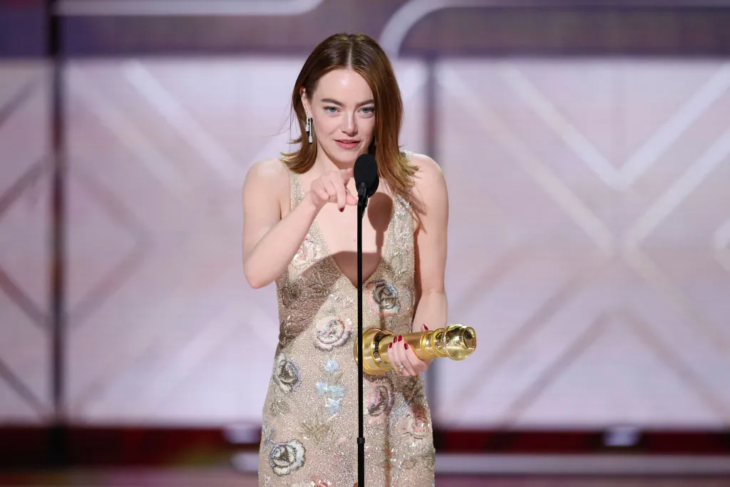 Emma Stone accepts her Golden Globe trophy on behalf of her role in “Poor Things”.
