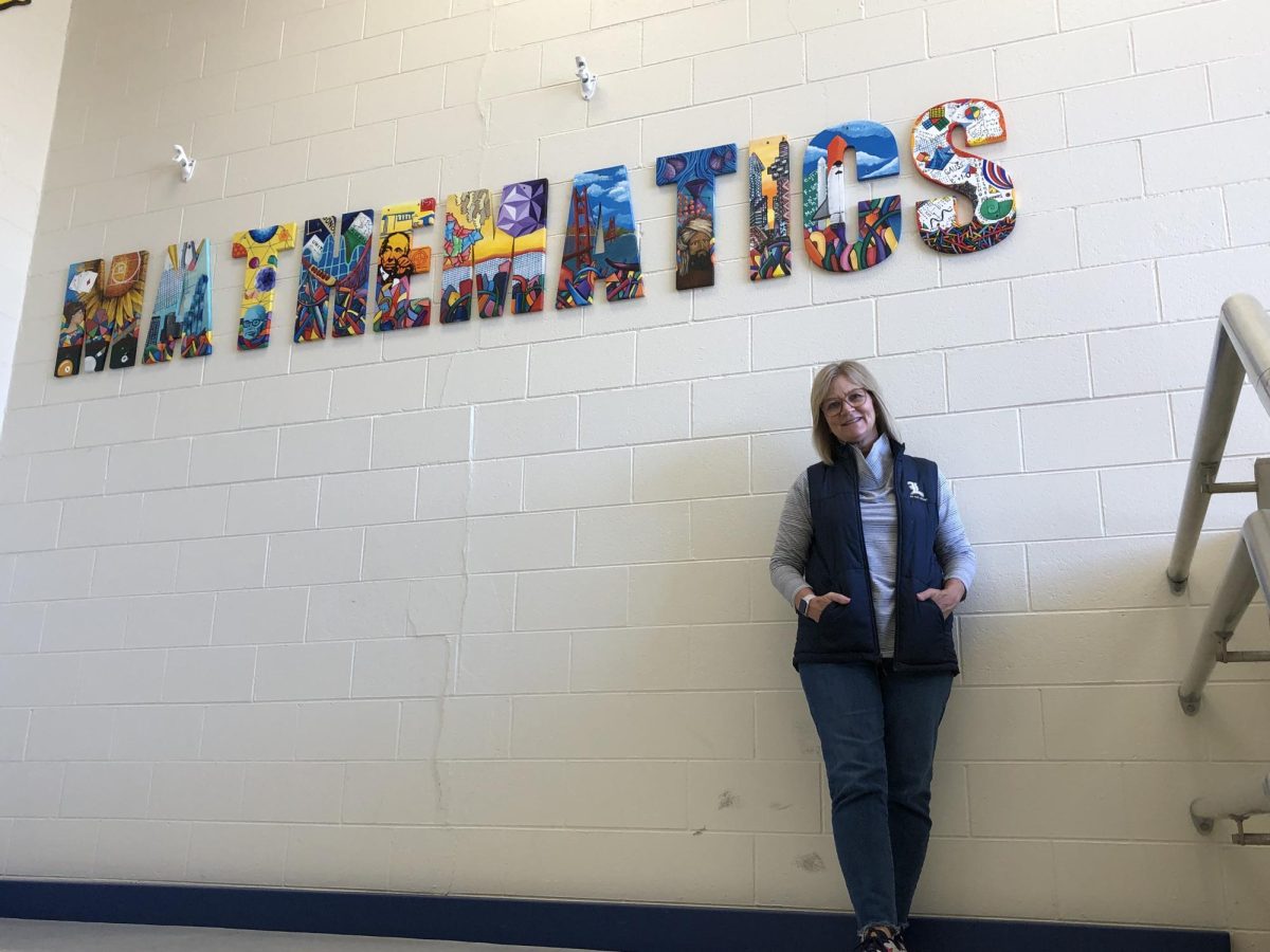 Kathy Young stands in front of the Mathematics sign by the fourth floor during her final days at LHS.