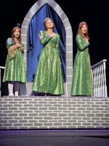 Sophomores Kate Malone, Julia Macari and Mykala Kunickis sing “I Know it’s Today”, representing young Fiona, older Fiona and teen Fiona, respectively.