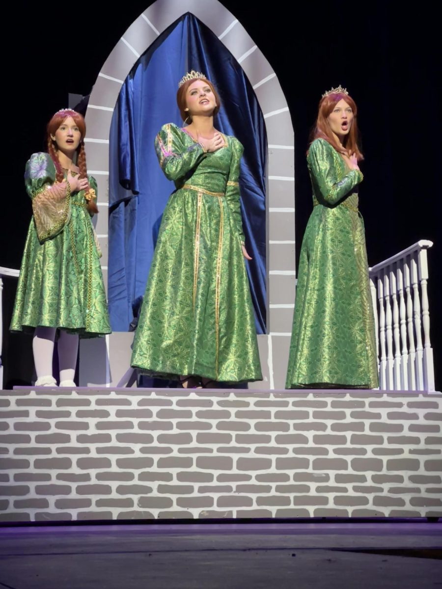 Sophomores Kate Malone, Julia Macari and Mykala Kunickis sing “I Know it’s Today”, representing young Fiona, older Fiona and teen Fiona, respectively.
