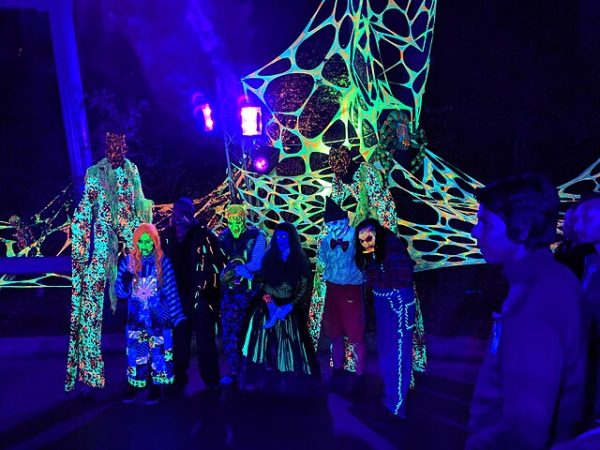 Actors in horrifying costumes prepare to scare at Fright Fest.
