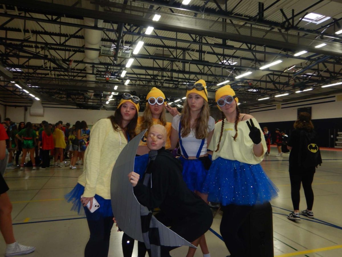 The winning group on Superheroes vs. Villains Day for the skit “Steal the Moon” posing with the moon prop.