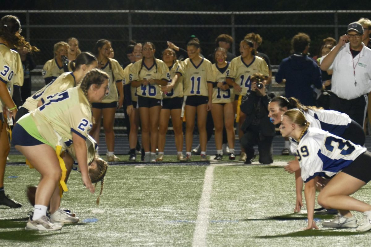 Two teams line up for play during the annual “Powder Puff” flag football game.
