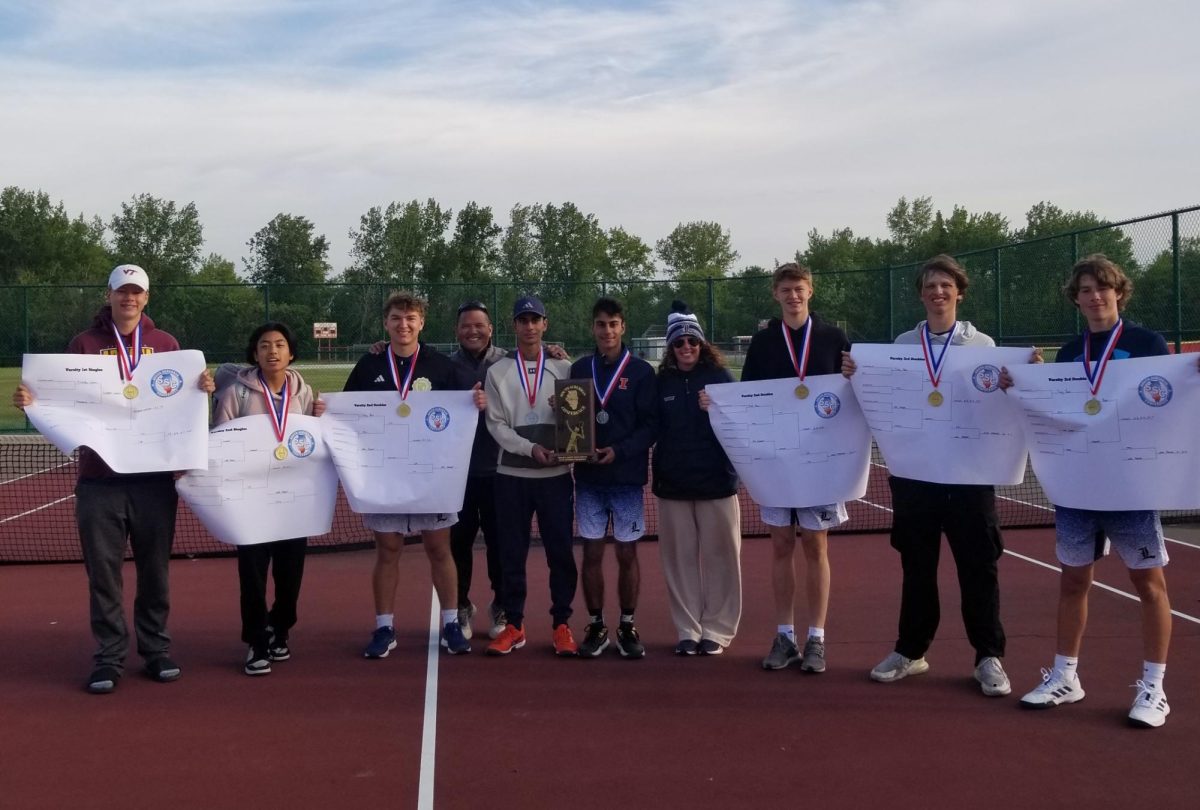The varsity boys tennis team poses with medals and brackets after a first place finish at the 2025 SSC conference meet. 