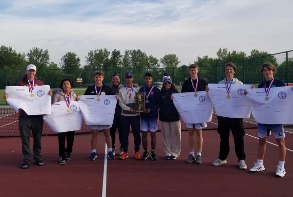 The varsity boys tennis team poses with medals and brackets after a first place finish at the 2025 SSC conference meet. 