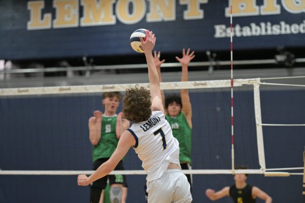 Kevin Collins spikes the volleyball during a game in the 2024-25 season.