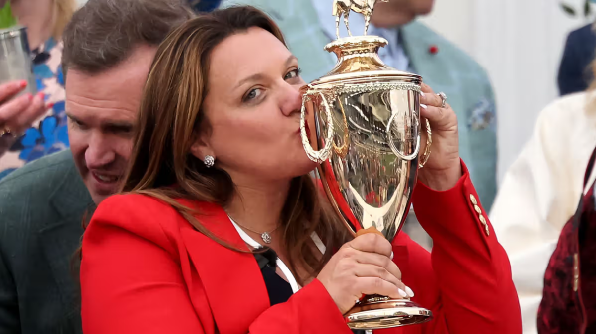 Cherie DeVaux, trainer of Golden Tempo, celebrates with the trophy in the winner's circle that follows the 152nd running of the Kentucky Derby. Photo courtesy of WRAL News.